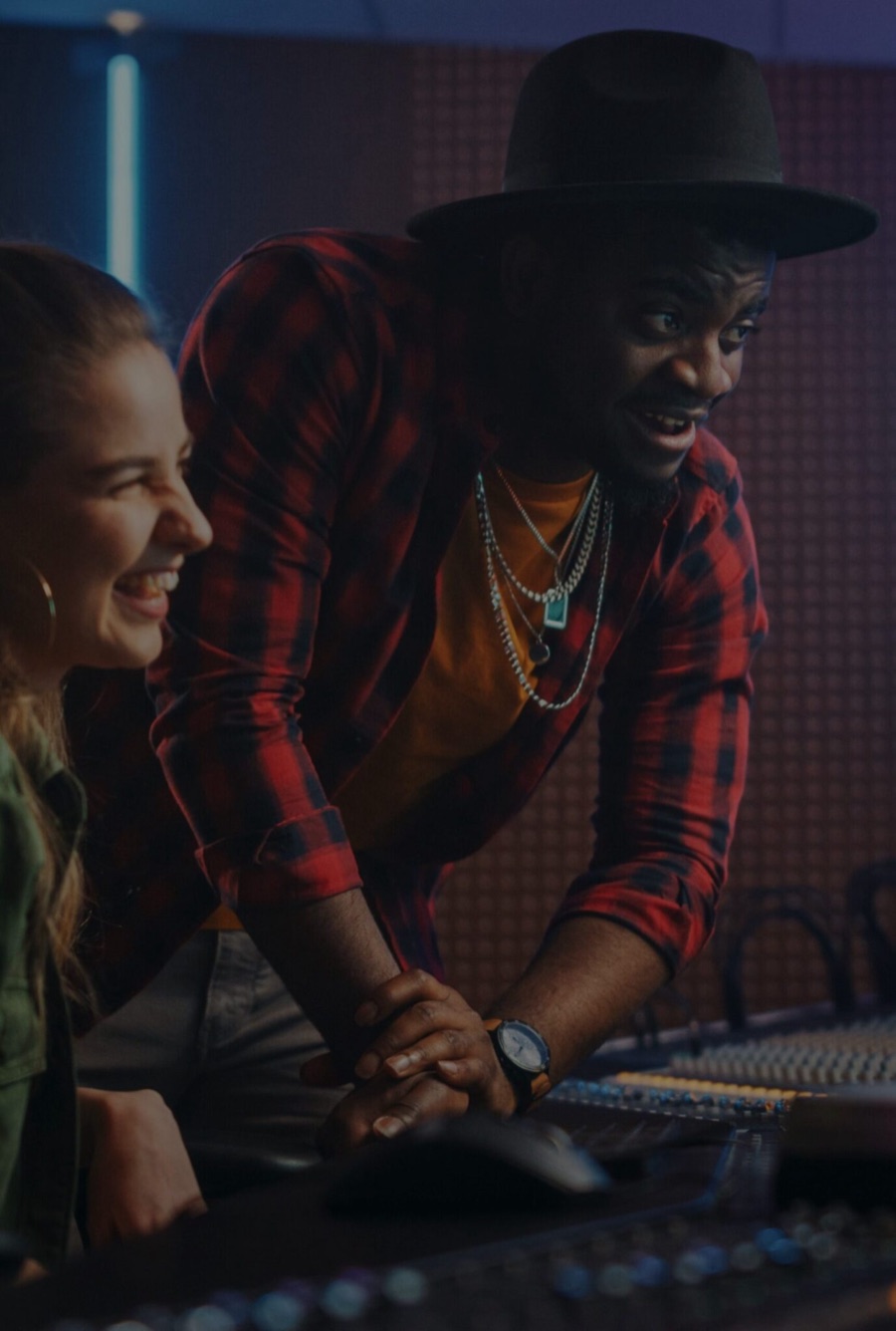 Two music professionals reviewing a mix in a studio
